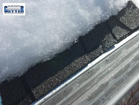 Asphalt shingle roof with GutterDome gutter guard and heat cable — melted snow.