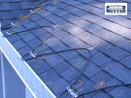 Asphalt shingle roof with GutterDome gutter guard and heat cable — serpentine.