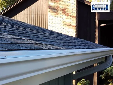 Asphalt shingle roof with GutterDome gutter guard — downspout.