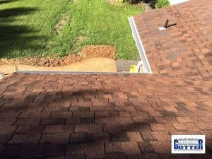 Asphalt shingle roof with a GutterDome gutter guard running through an inside corner and long valley