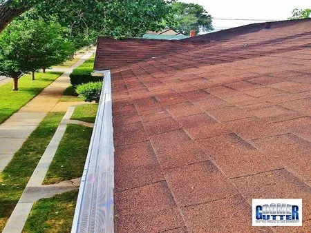 Asphalt shingle roof with GutterDome gutter guard — street.