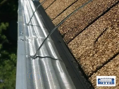 Asphalt shingle roof with GutterDome Adjustable gutter guard — gutter straps - top view close.