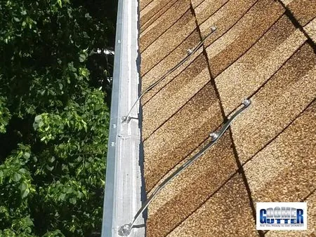 Asphalt shingle roof with GutterDome Adjustable gutter guard — gutter straps - trees.