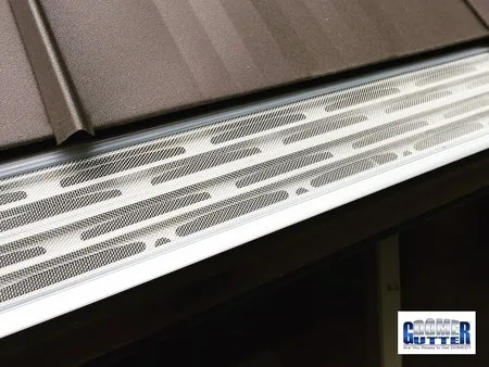 Metal roof with GutterDome Adjustable Magma gutter guard — straight & brown.