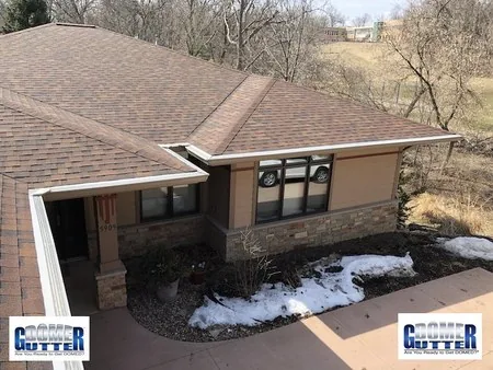 Asphalt shingle roof with GutterDome gutter guard — several miters in a single run.